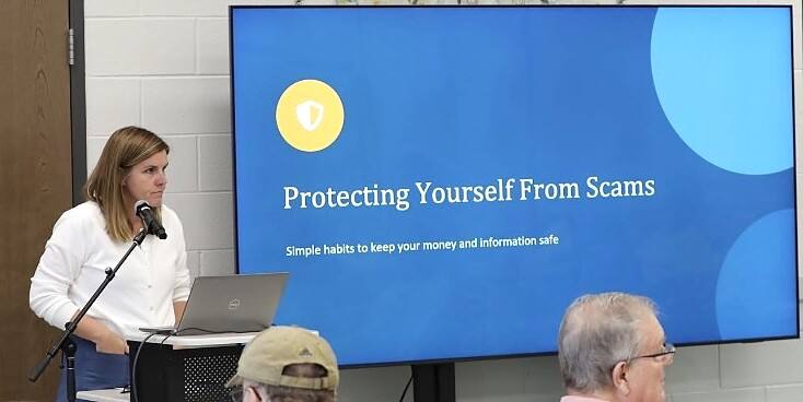 Christy Lillie presenting a scam prevention talk to community members.