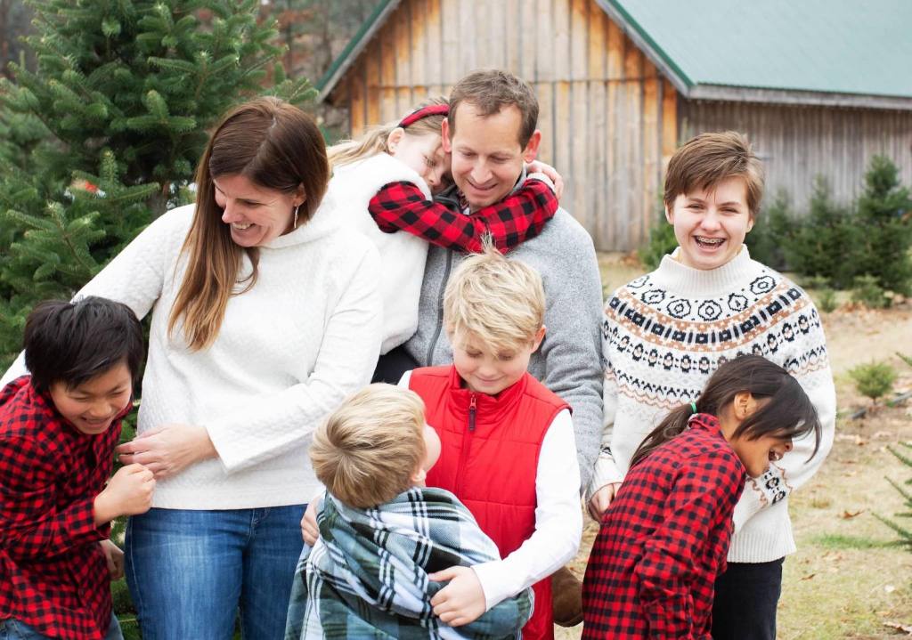 Christy Lillie with her husband and their six children at a Christmas tree farm.
